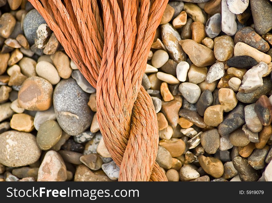 A close up shot of some rope washed up on a pebble beach. A close up shot of some rope washed up on a pebble beach