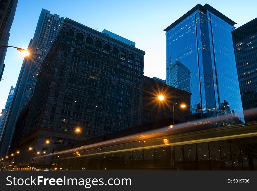 A slow shutter captures some tail lights and the street lights in downtown Chicago in the half light. A slow shutter captures some tail lights and the street lights in downtown Chicago in the half light.