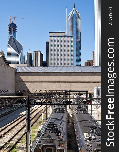 The railway runs into the heart of downtown Chicago. Trains in the foreground and city skyline in the background. The railway runs into the heart of downtown Chicago. Trains in the foreground and city skyline in the background.