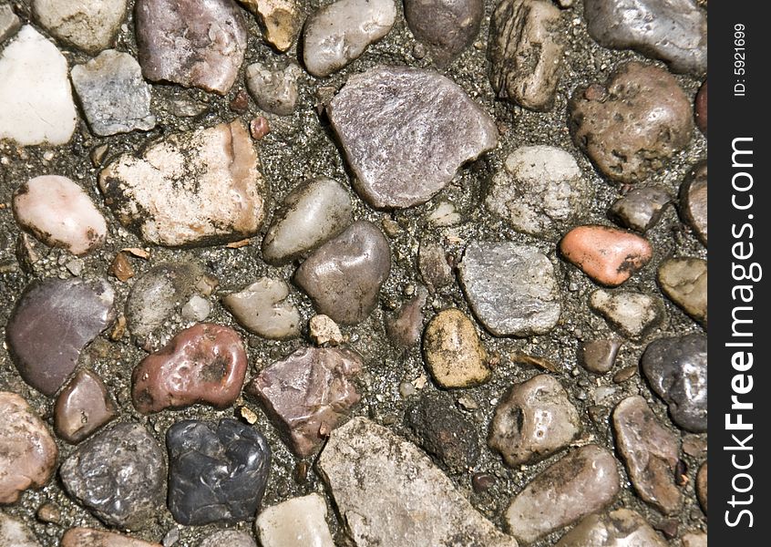 A closeup pebble rock background of various types of rocks. A closeup pebble rock background of various types of rocks