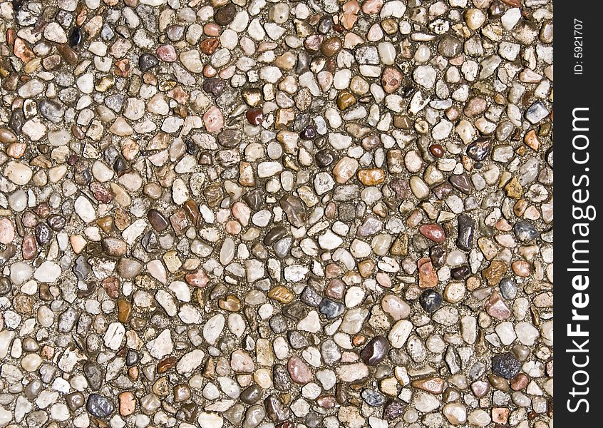 A pebble rock background of various rocks. A pebble rock background of various rocks.