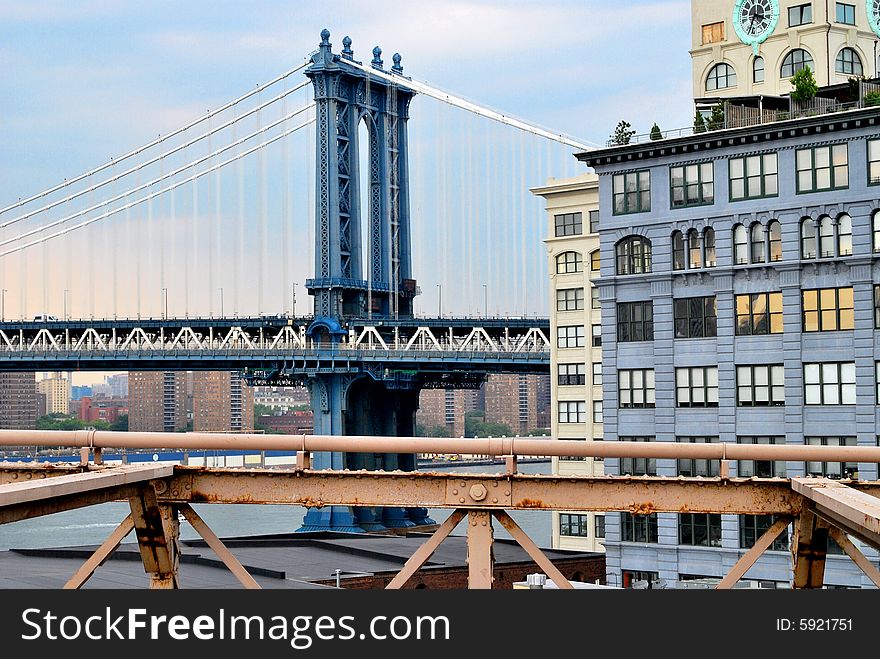 Manhattan Bridge with buildings in foreground.