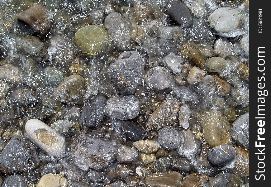 Pebble washed streaming sea water, and forming background, invoice. Pebble washed streaming sea water, and forming background, invoice