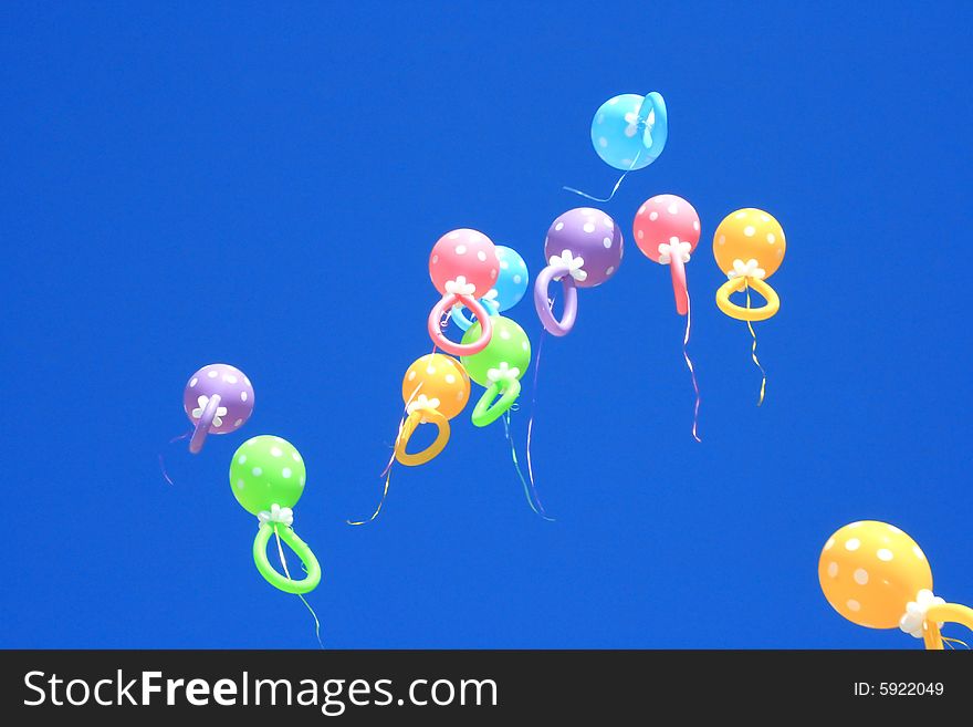 Colorful balloons flying in the blue sky.