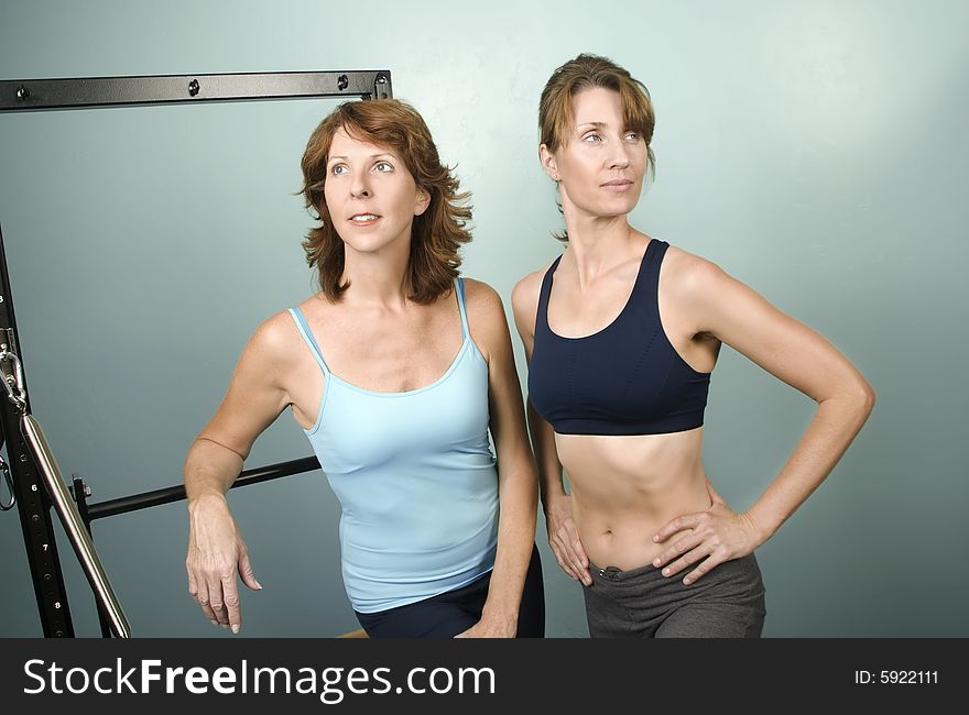 Portrait of Two Pretty Personal Trainers in a Gym. Portrait of Two Pretty Personal Trainers in a Gym