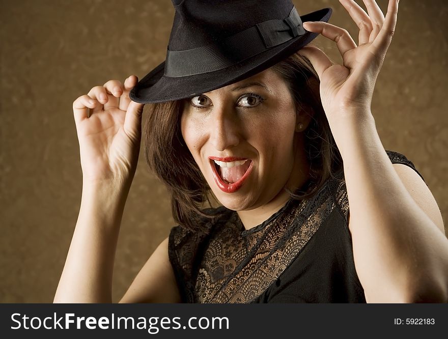 Pretty Hispanic Woman Tipping Her Fedora Hat. Pretty Hispanic Woman Tipping Her Fedora Hat