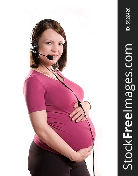 Pregnant woman wearing earphones with a microphone