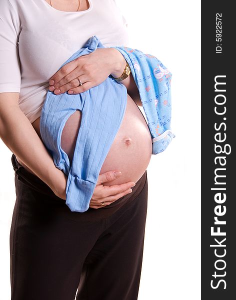 Pregnant woman with her future baby's clothes