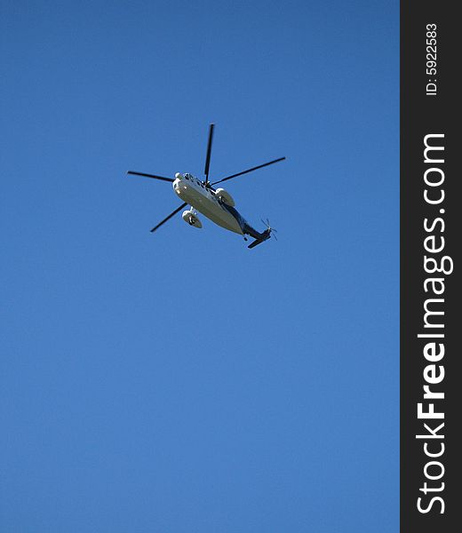 Helicopter flying in the perfect blue sky. Helicopter flying in the perfect blue sky