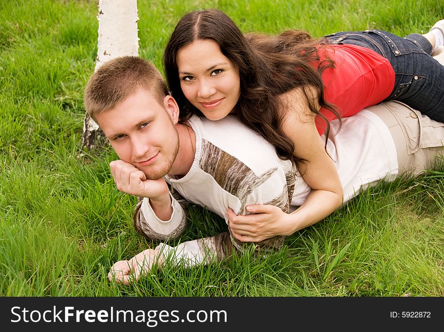 Happy young couple outdoor on the grass. Happy young couple outdoor on the grass