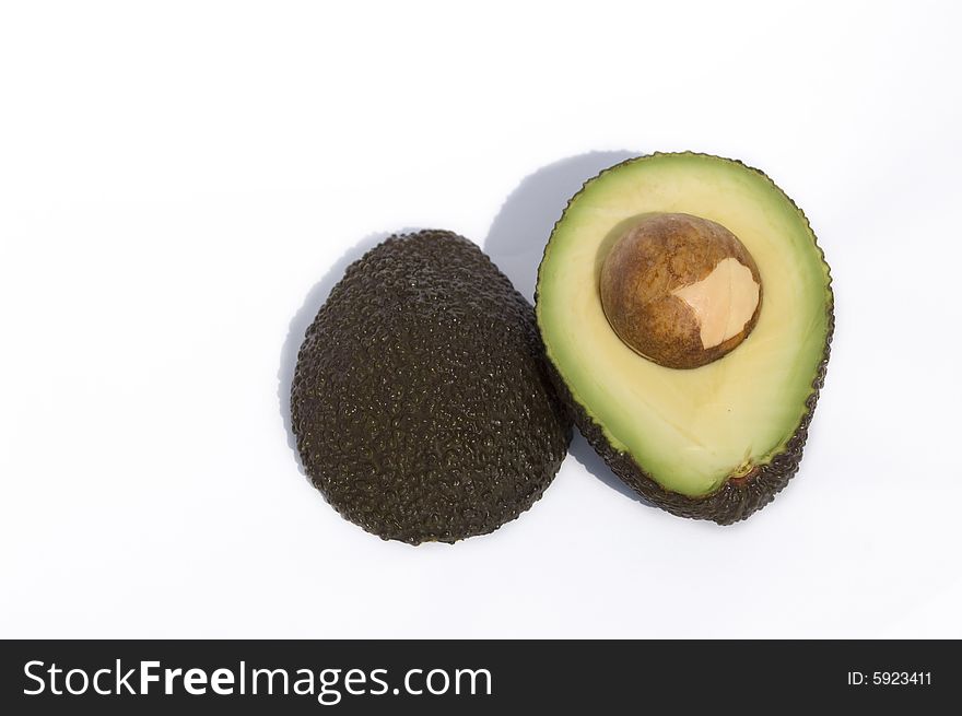 Two half of avocado with seed