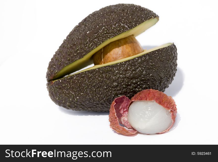 Two half of avocado with seed and litchi. Two half of avocado with seed and litchi