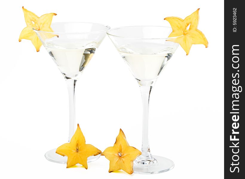 Glass of martini and slice of carambola on a white background. Glass of martini and slice of carambola on a white background