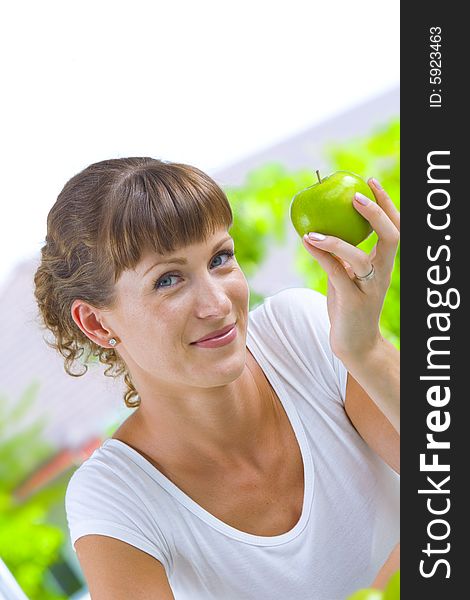 High key portrait of young woman with apple. High key portrait of young woman with apple