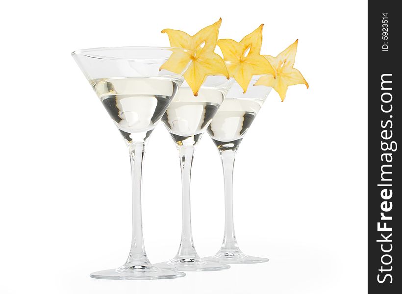 Glass of martini and slice of carambola on a white background. Glass of martini and slice of carambola on a white background