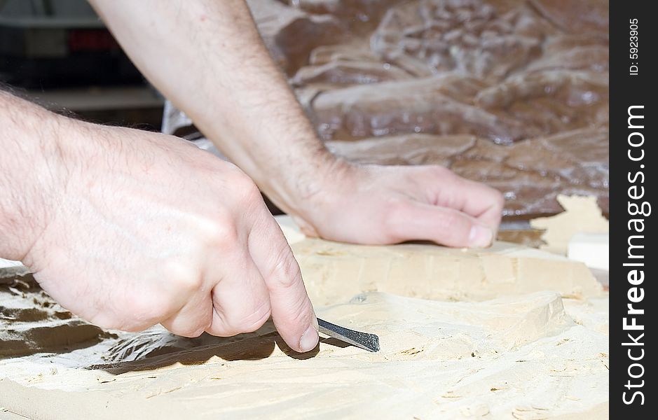 Hands of the carver. Work place. Hands of the carver. Work place