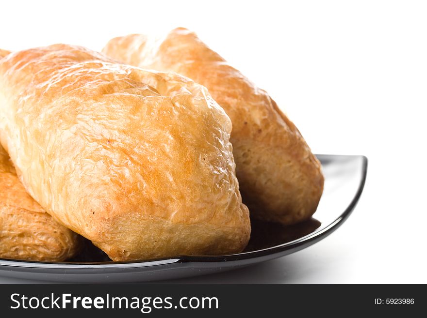 Fresh rolls on a plate on a white background