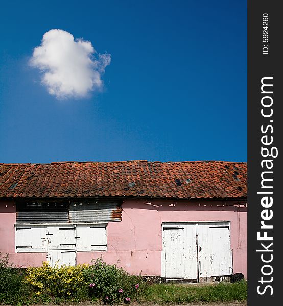 A decaying barn under a clear blue sky. Includes copy space.