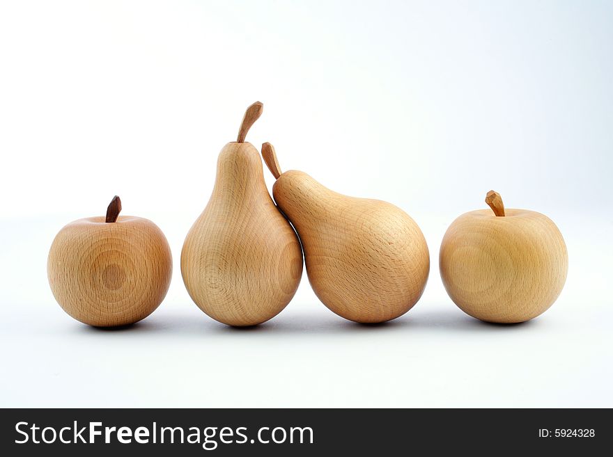 Wooden pears with an apples on a white background