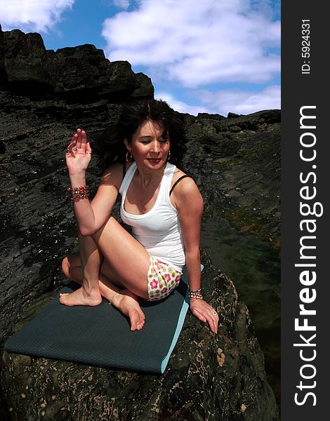 A beautiful woman doing yoga to show a healthy way to live a happy and relaxed lifestyle in a world full of stress. A beautiful woman doing yoga to show a healthy way to live a happy and relaxed lifestyle in a world full of stress
