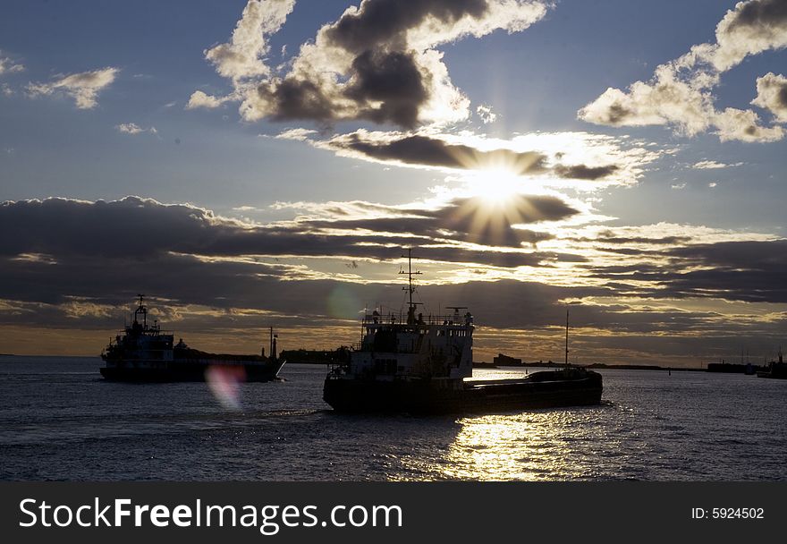 Sea in the evening, cargo ships at sunset
