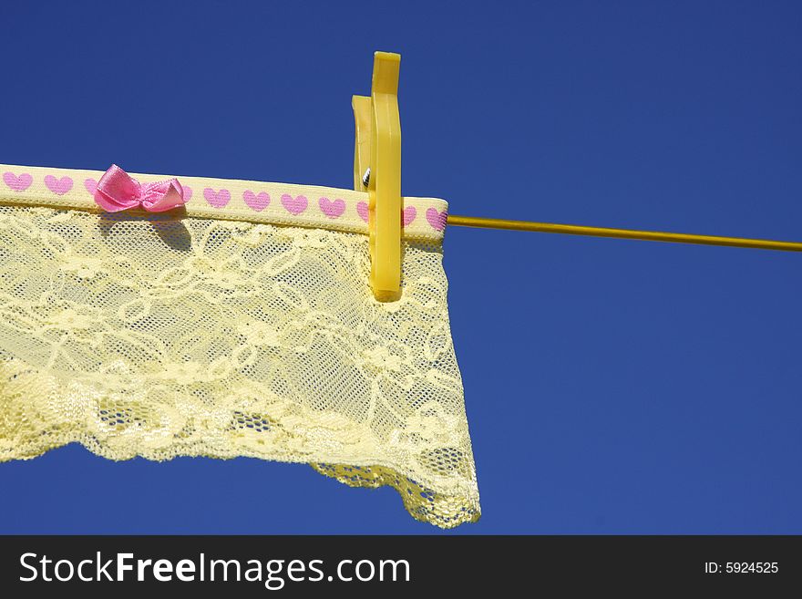 Yellow Clothes, lingerie on washing laundry line blue skies. Yellow Clothes, lingerie on washing laundry line blue skies
