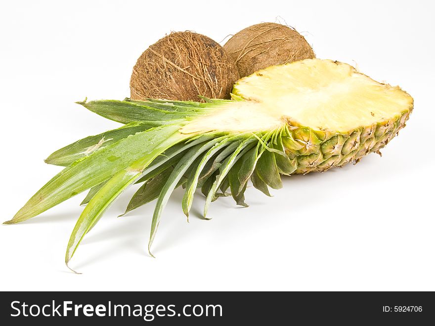 Pineapple and coconuts isolated on white. Pineapple and coconuts isolated on white.