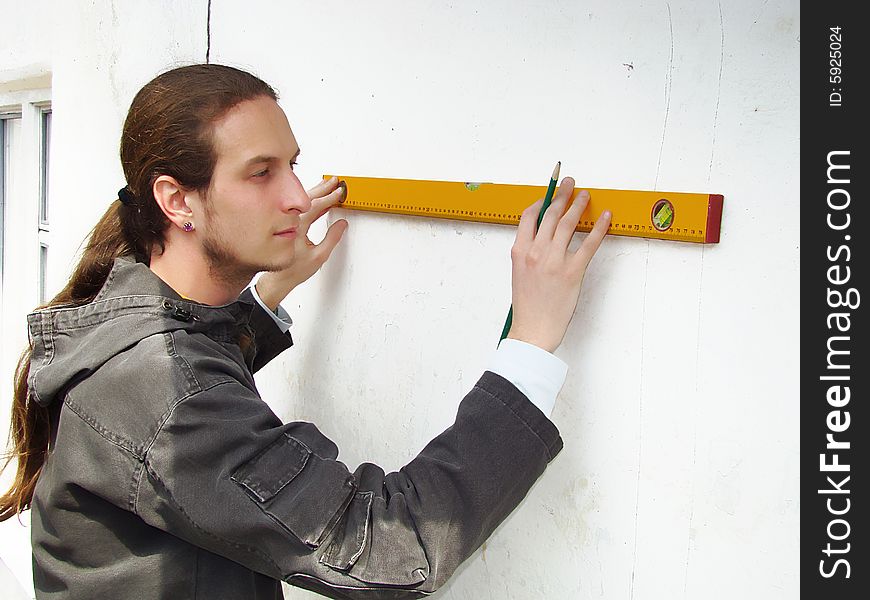 Young adult man with a line and pencil.