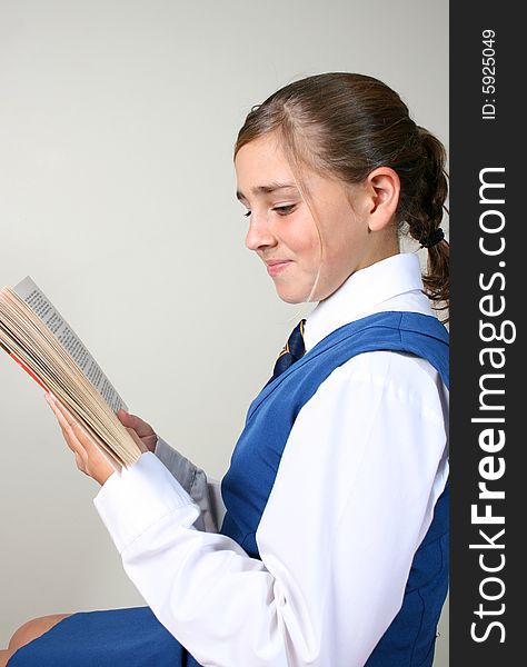 Teenage School girl busy with her homework, wearing uniform