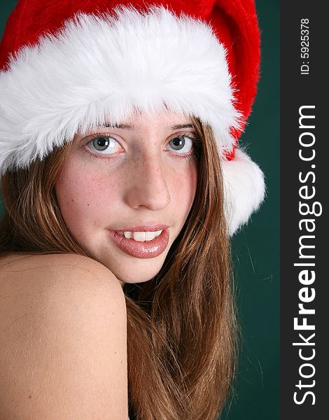 Brunette Teenager wearing a fluffy christmas hat