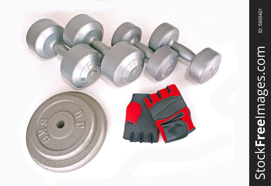 Various types of weights & a pair of red gloves. Various types of weights & a pair of red gloves