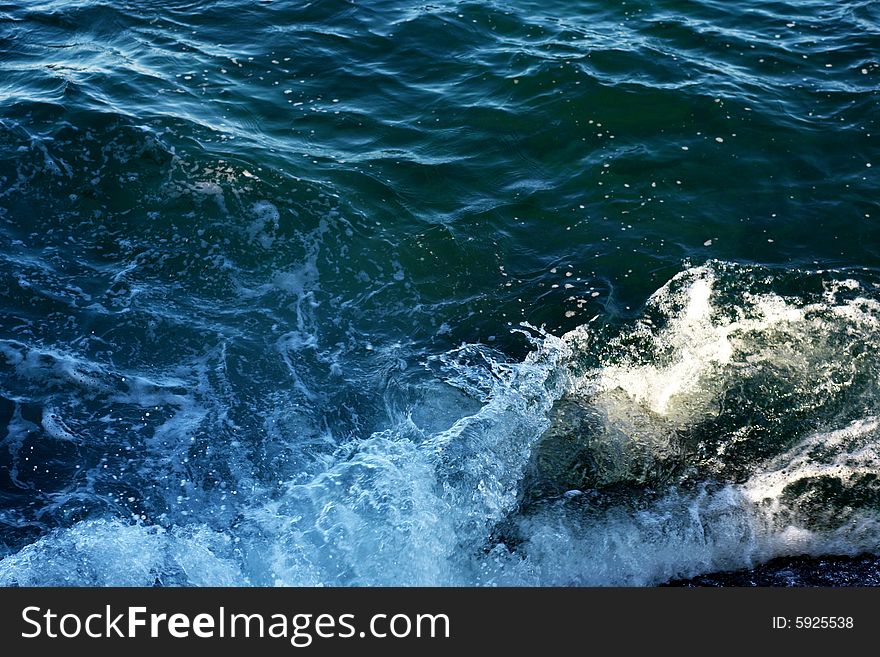 An image of a wave in blue sea