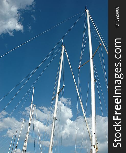 Storm-clouds and several masts. Storm-clouds and several masts