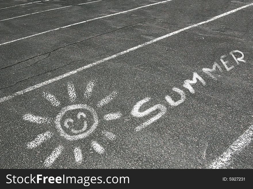 A drawing of a sun and the word summer written on a parking lot with chalk and isolated on a white background. A drawing of a sun and the word summer written on a parking lot with chalk and isolated on a white background