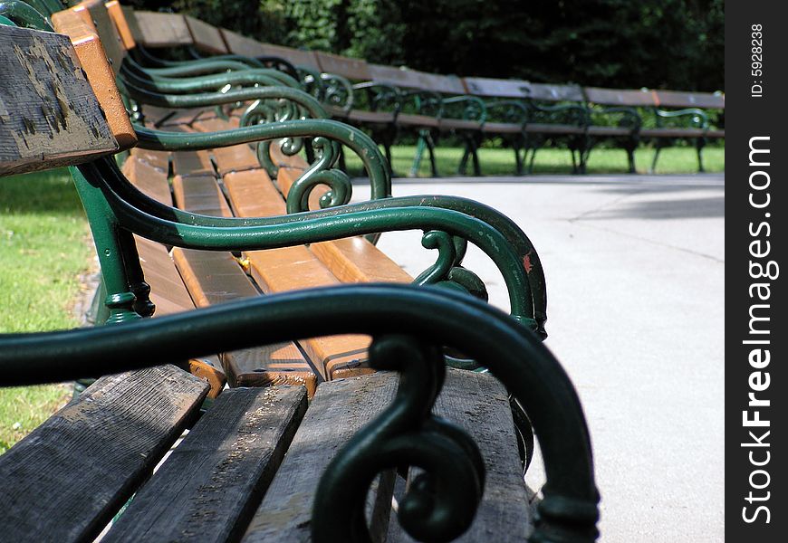 Bunch of empty benches in the park at sunny day. Bunch of empty benches in the park at sunny day