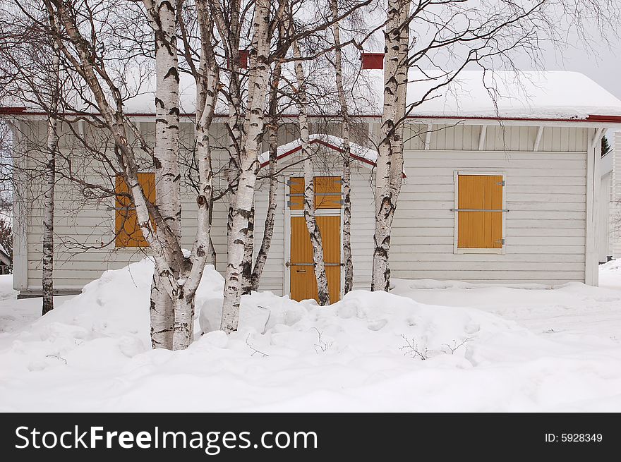 Snow covered wooden house in the winter