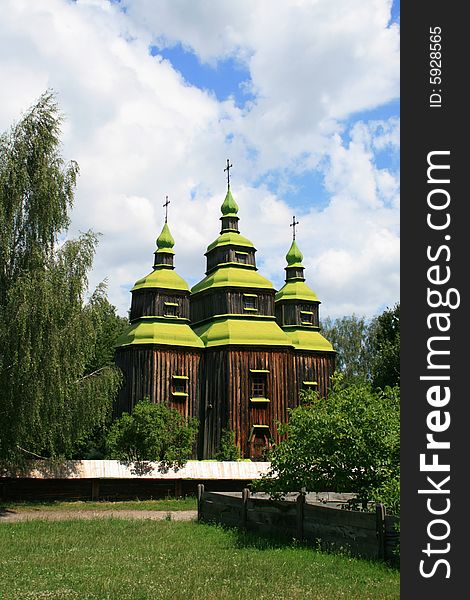 Ancient wooden church worth between green trees