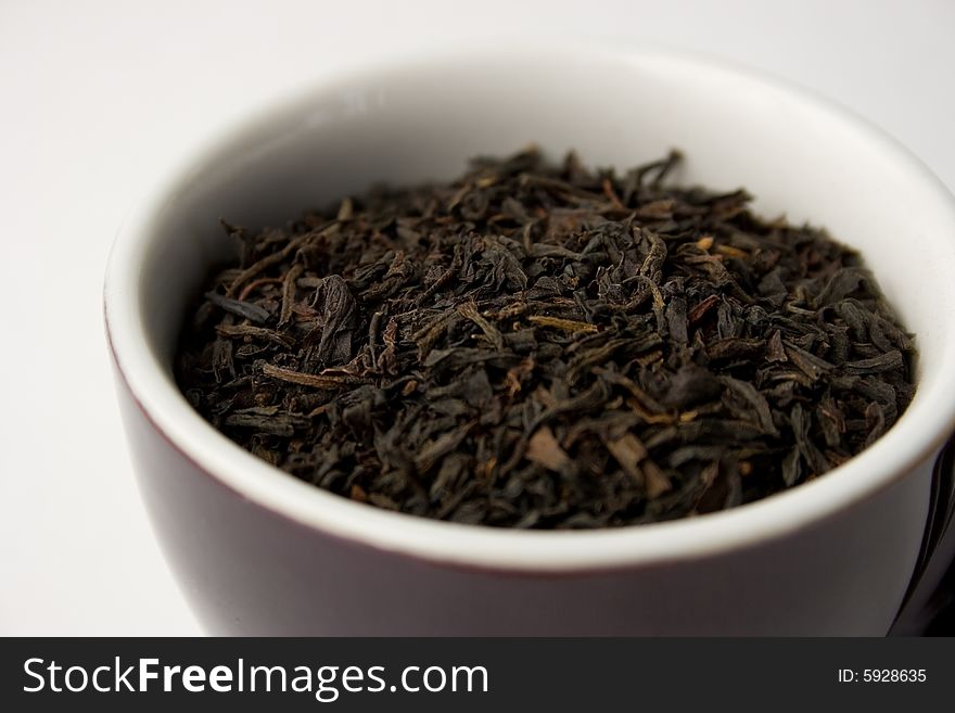 Loose tea leaves in a cup.  Narrow focus on tea leaves. Loose tea leaves in a cup.  Narrow focus on tea leaves.