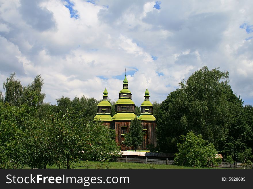 Ancient wooden church worth between green trees