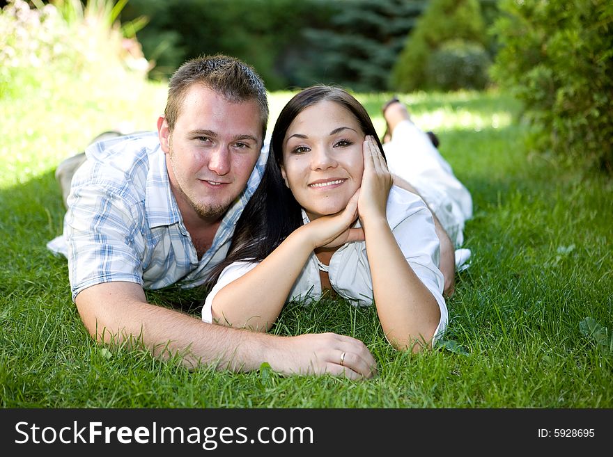 Happy couple relaxing on grass. Happy couple relaxing on grass
