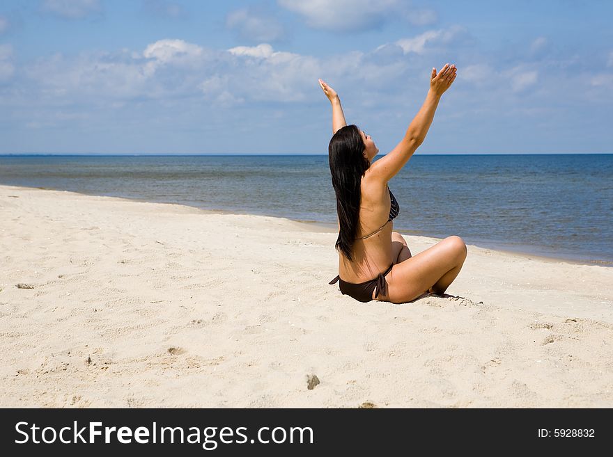 Attractive brunette woman relaxing on beach. Attractive brunette woman relaxing on beach