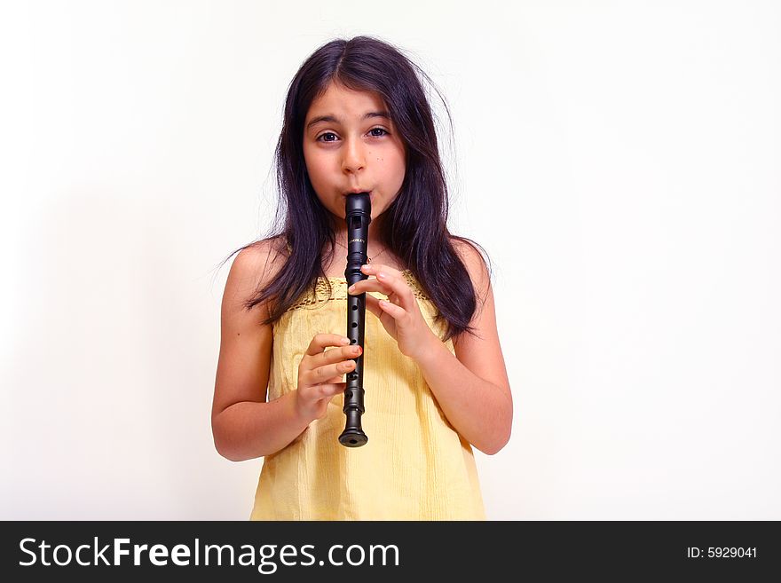 8 year old girl playing a recorder. 8 year old girl playing a recorder