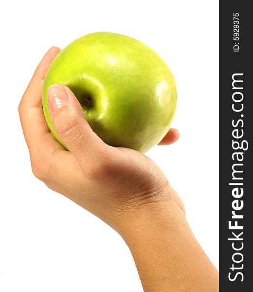 Green apple in a female hand isolated on a white background