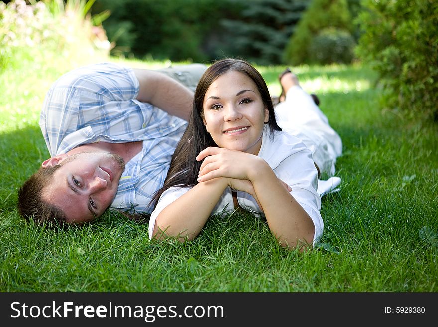 Happy couple relaxing on grass. Happy couple relaxing on grass