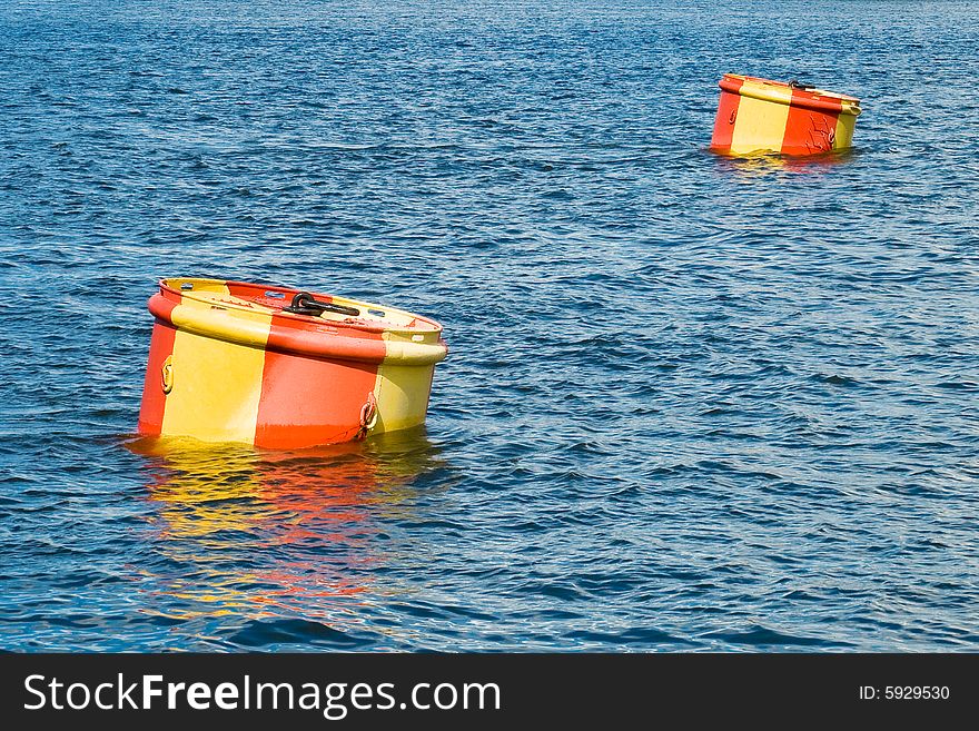Two buoys on a surface of water.