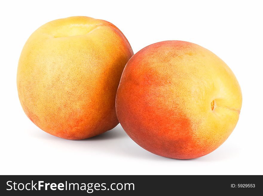 Two peaches on a white background. Isolated.