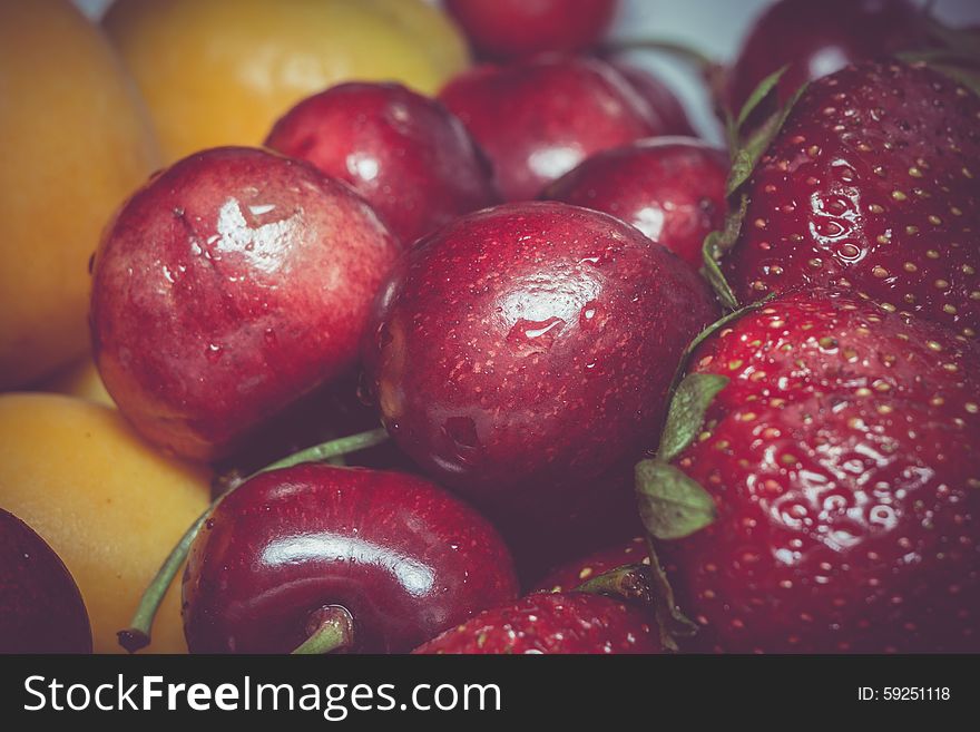 Fresh ripe apricot, cherry and strawberry close up, vintage background. Fresh ripe apricot, cherry and strawberry close up, vintage background.