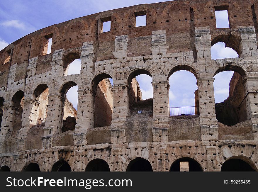 Wall Coliseum in a sunny day, blue sky arches windows Rome Italy. Wall Coliseum in a sunny day, blue sky arches windows Rome Italy