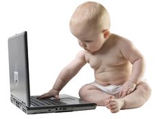 Baby Typing Somthing On Laptop. Royalty Free Stock Images