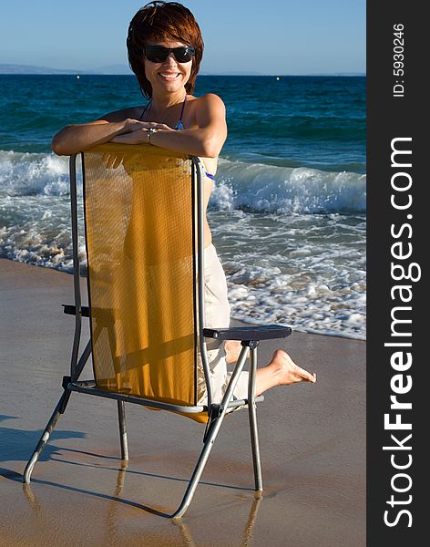 Young beautiful woman has a rest on coast of ocean